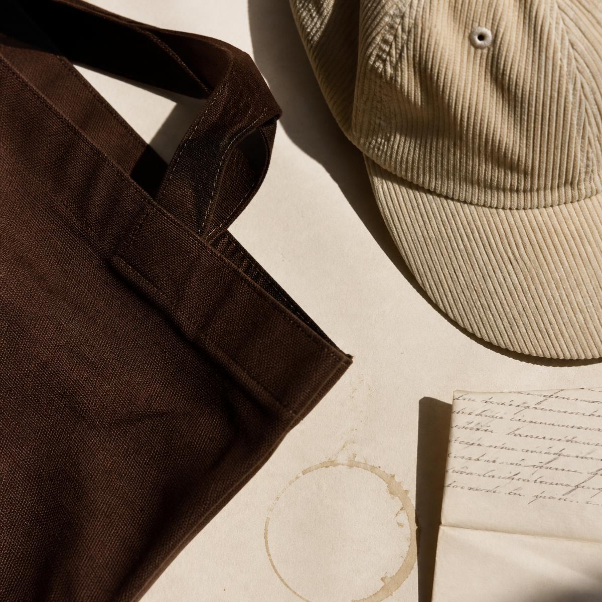 Cream corduroy cap on ivory paper